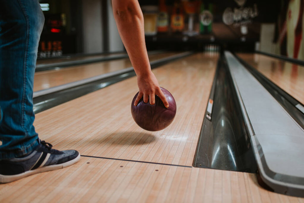 Detailní záběr na ruku bělocha házející míč v bowlingovém klubu - Fotografie, Obrázek