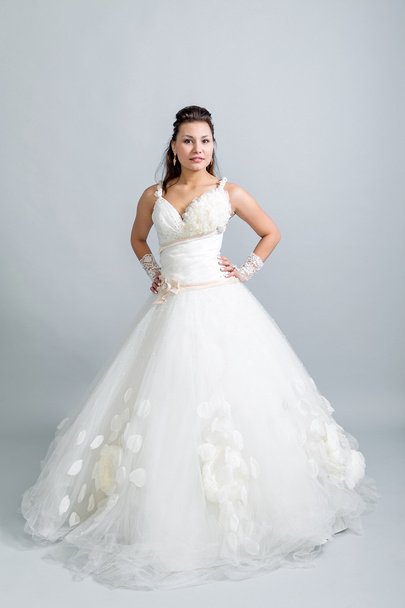 girl in a white wedding dress hands on belt - Fotó, kép
