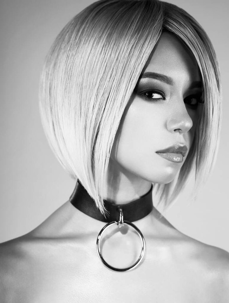 Fashion studio portrait of lovely asian woman with blonde short hair. Bright makeup. Fashionable haircut. Sexy young model in night club - 写真・画像
