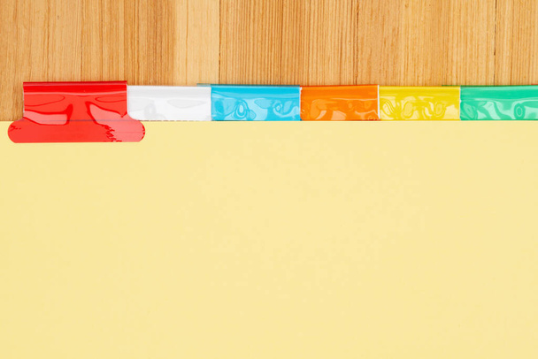 Blank yellow file tabs on wood desk background with copy space for your school or business message - Photo, Image