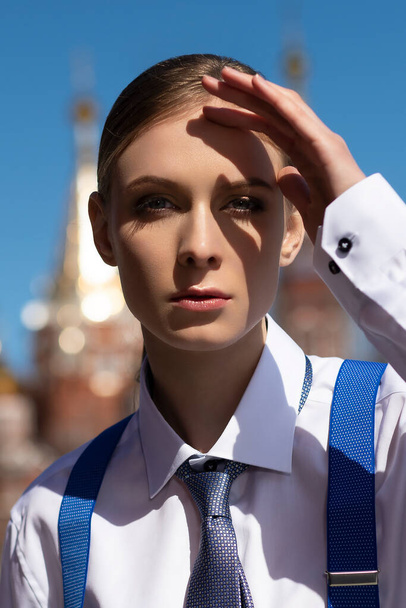 A young beautiful girl dressed in a mens suit poses - Фото, зображення