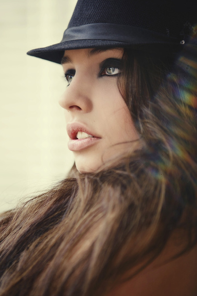 Young woman in black hat - Valokuva, kuva