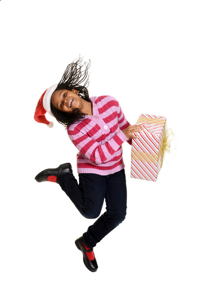 Jamaican child jumping with christmas gift - Zdjęcie, obraz