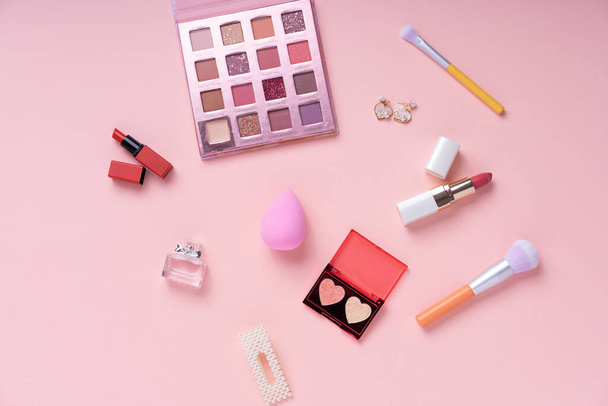 Top view. Flat lay. Cosmetic pink collection set on bright pink background. - Photo, Image