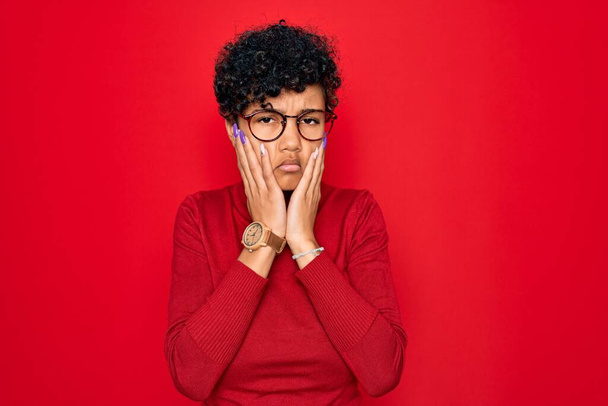 Young beautiful african american afro woman wearing turtleneck sweater and glasses Tired hands covering face, depression and sadness, upset and irritated for problem - Photo, Image