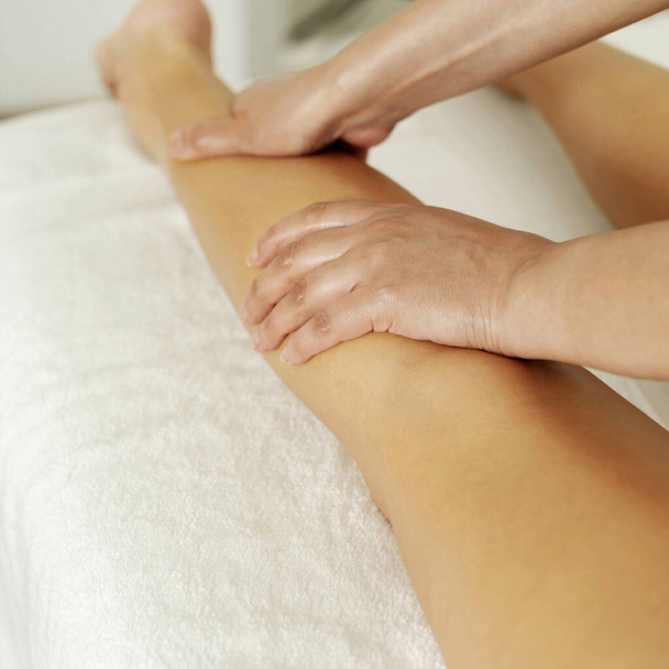 Woman enjoying a leg massage - Foto, afbeelding