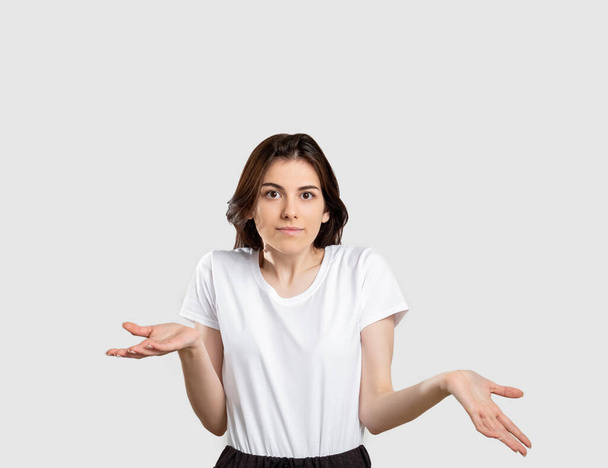 shrug gesture confused woman raising shoulders - Foto, Imagen