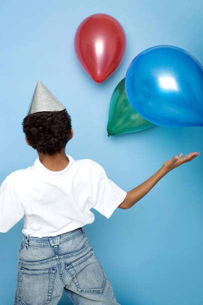 Boy playing balloons, studio shot - Zdjęcie, obraz