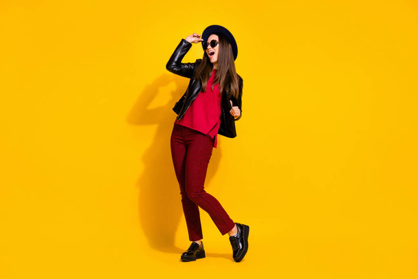 Full length photo of carefree crazy girl in red clothes spring shoes screaming yeah isolated over bright yellow background - Foto, Imagen