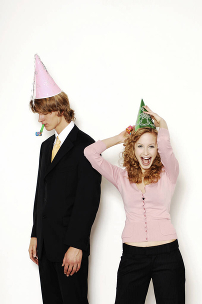 Businessman and businesswoman in party hat - Photo, image