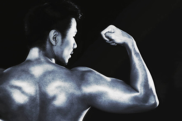young man flexing muscle - 写真・画像