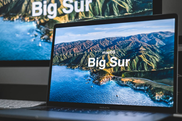 MacBook with Mac OS Big Sur background logo on the screen, new operating system which will be released in the fall of 2020. High quality photo - Foto, imagen