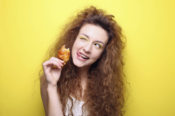Woman enjoying mini croissant - Fotoğraf, Görsel