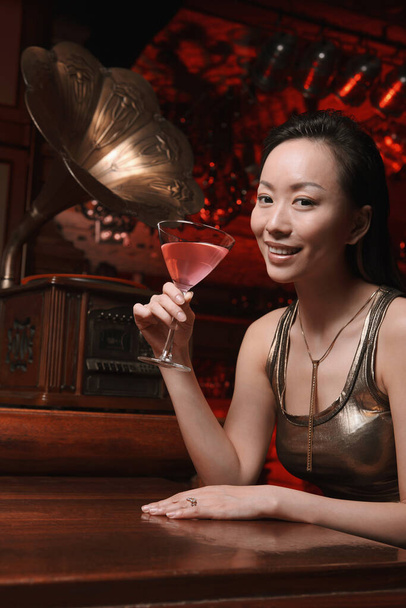 Woman enjoying a glass of cocktail - Photo, image