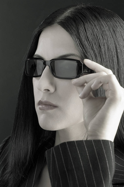Close-up of a lady in office attire wearing a sunglass - Фото, изображение