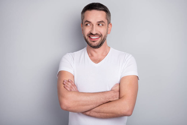 Close-up portrait of his he nice attractive cheerful cheery curious muscular guy folded arms creating new idea isolated over light grey pastel color background - Photo, image