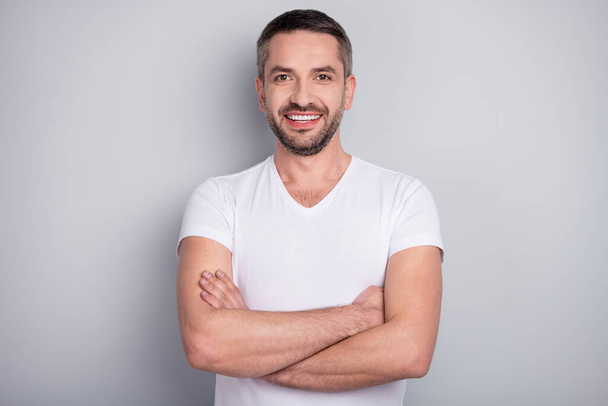 Close-up portrait of his he nice attractive cheerful cheery content muscular guy folded arms isolated over light grey pastel color background - Фото, зображення