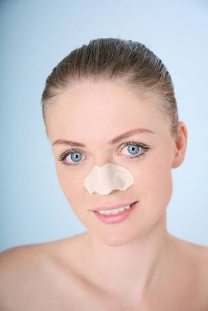 Smiling woman with cleansing strip on her nose - Photo, image