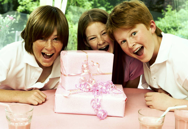 A birthday girl and her brothers screaming unbelievably at the presents she received - Foto, Imagem