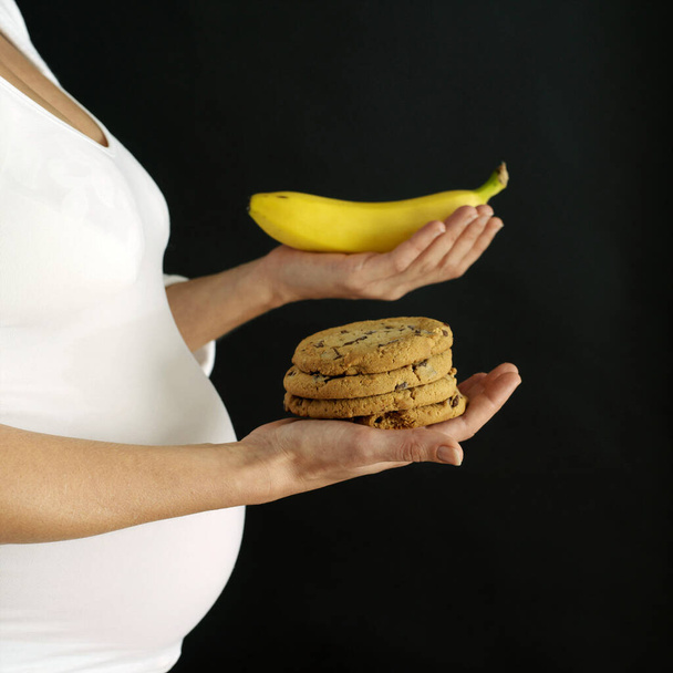 Pregnant woman with cookies and banana - Foto, Imagem