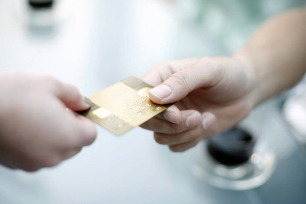 Paying with a gold credit card - Foto, Bild
