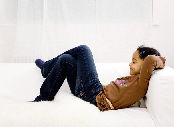 Girl crossing her legs while resting on the couch - Foto, afbeelding