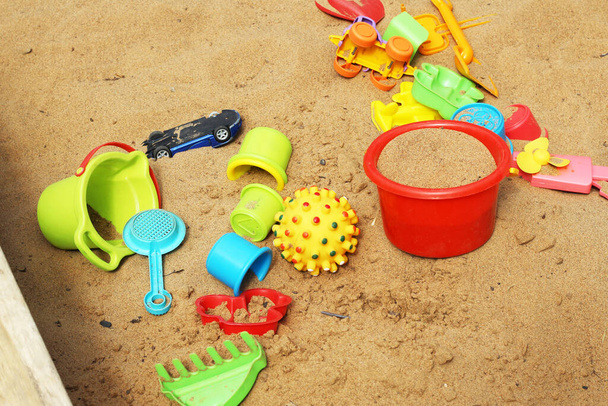 Children's colorful toys in the sand, summer - Photo, Image