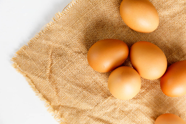 Close up Top view fresh chicken eggs on linen tablecloth with copy space.  - Photo, image