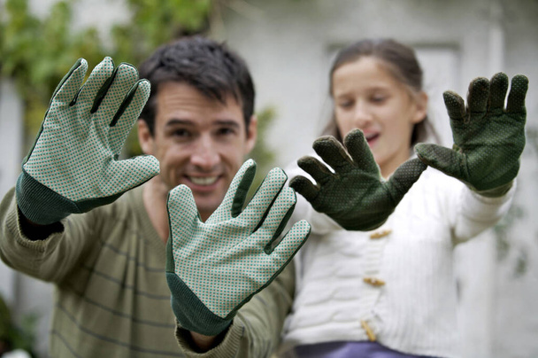 Man and girl with gardening gloves - Φωτογραφία, εικόνα