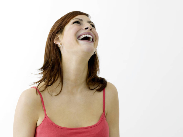 Woman laughing, studio shot - Photo, Image