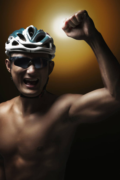 Man in cycling helmet celebrating his success - Zdjęcie, obraz