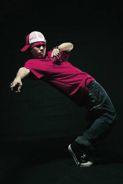 Young man making a breakdance move - Fotó, kép