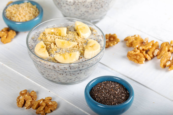 Chia pudding made with milk, banana and decorated walnut - Photo, Image