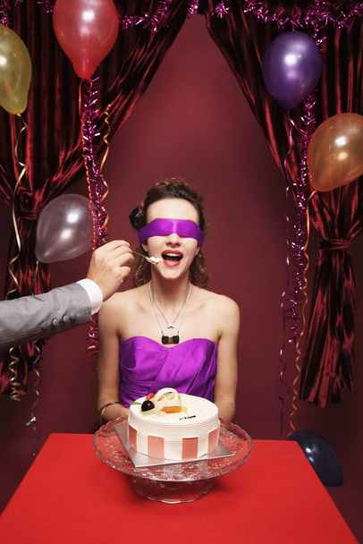 Man feeding blindfolded woman cake - Photo, image