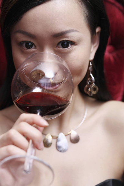 Woman enjoying a glass of wine - Valokuva, kuva