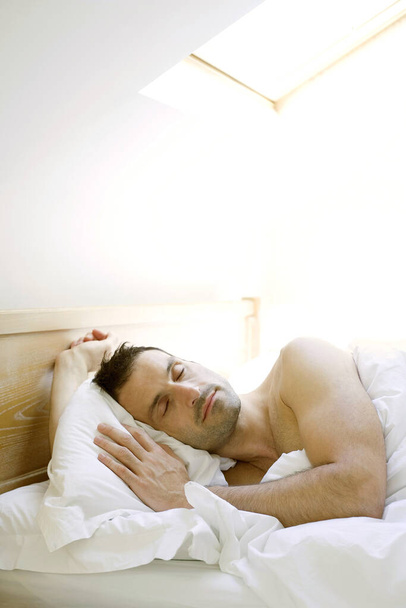 young Man sleeping in bed - Foto, Bild