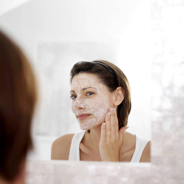 Woman applying facial mask - Fotó, kép