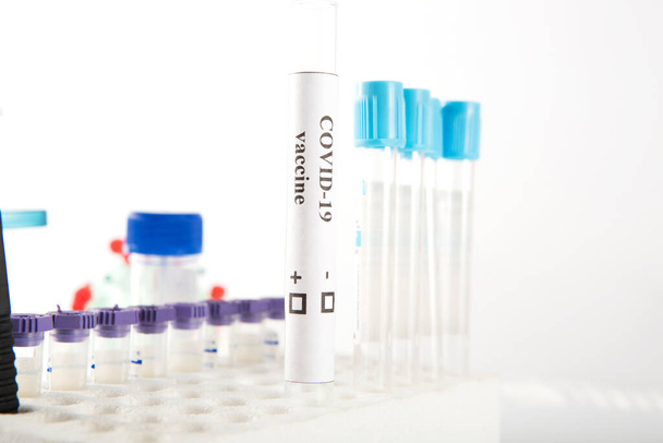 Test tube with a vaccine against coronovirus infection COVID-19 on a white background - Φωτογραφία, εικόνα