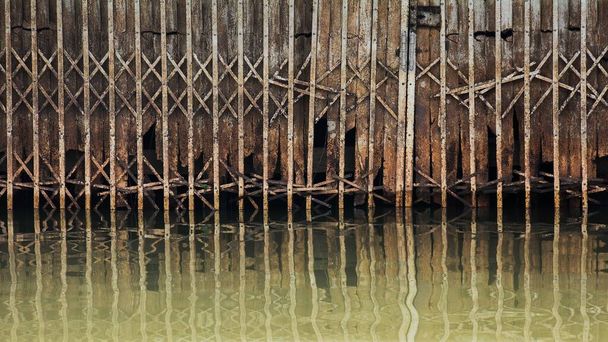 oxidado y el daño de la antigua puerta de metal deslizante en el agua
 - Foto, Imagen