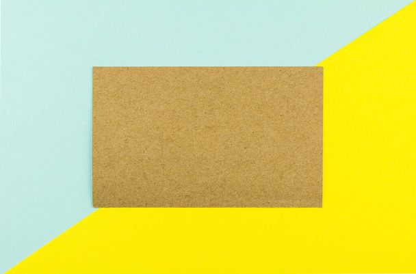 Carta marrone su sfondo di carta blu e giallo. - spazio per il testo - Foto, immagini