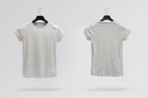 Front and back sides of female grey melange cotton t-shirt on a hanger isolated on a white background. T-shirt without print - Φωτογραφία, εικόνα