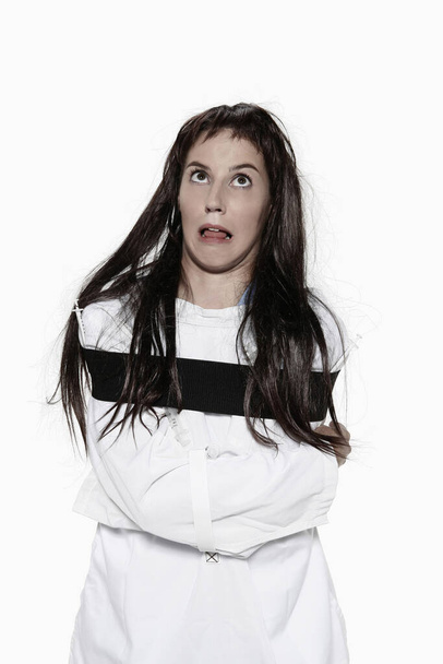 Woman in straitjacket on white  - Foto, immagini