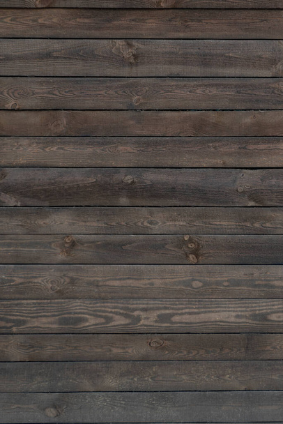 Wooden background. Old dark wooden surface. Wood planks. Coarse texture. Vertical frame. - Photo, Image