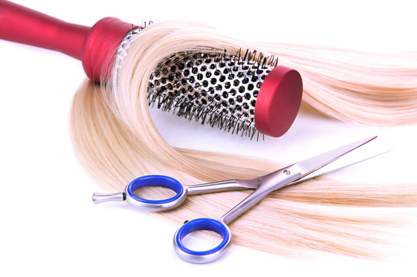 Long blond hair with hairbrush and scissors isolated on white - Photo, image