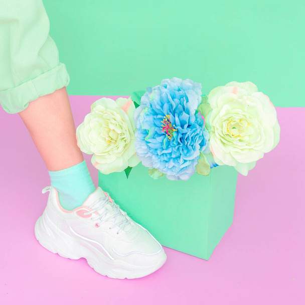 Stylish shoes and roses. White Sneakers. Minimal Summer mood concept. Ideal for bloggers, websites, magazines, business owners, instagram fashion page. Trendy monochrome design - 写真・画像