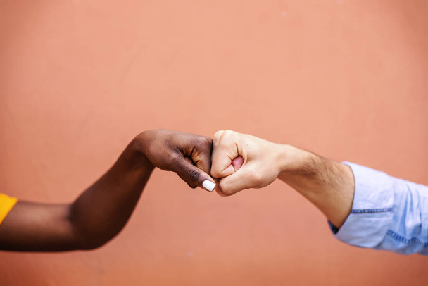 Closeup of multicultural friends giving fist bump to each other. - Photo, Image