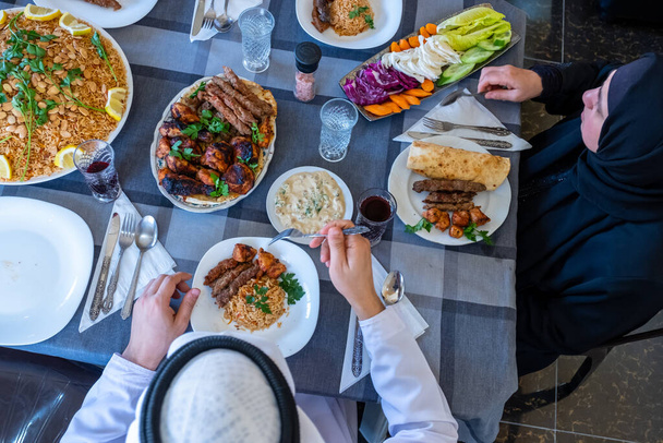Boldog arab muszlim család élvezi az ételt együtt ramadánban - Fotó, kép