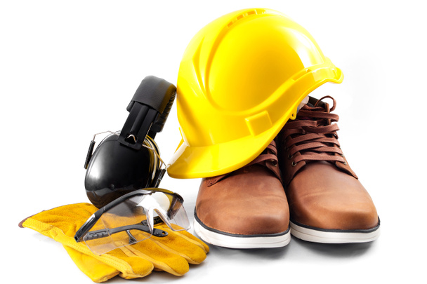 Work safety concept with hard hat, protective gloves, boots, eye safety glasses and hearing protecting noise canceling earmuffs isolated on white background with a clipping path included - Photo, Image
