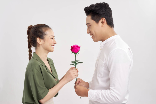 romantic moment: young man giving a rose to his girlfriend - Fotoğraf, Görsel
