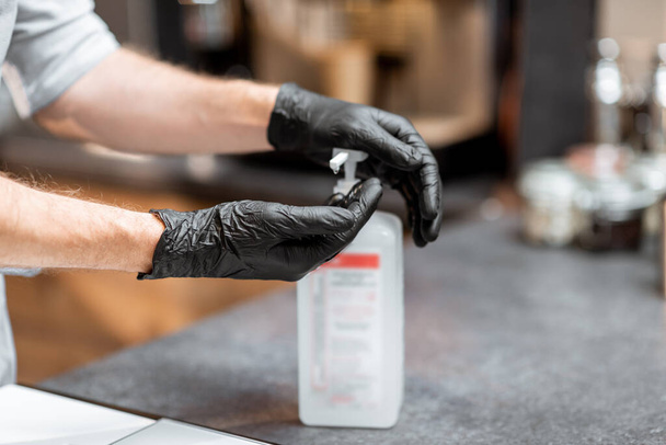 Seller disinfecting hands - Φωτογραφία, εικόνα